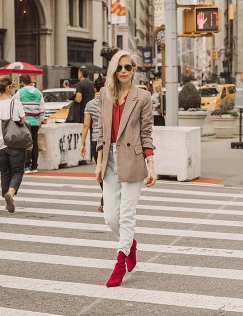 High waisted jeans with a loose formal coat and red sweater