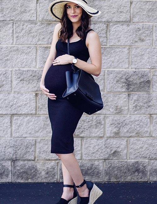 Black noodle strap dress with a hat for pregnancy photoshoot