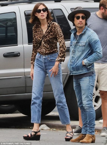 Alexa Chung proves her fashion credentials in an eye-catching leopard print shirt and vintage jeans as she steps out with pals in New York