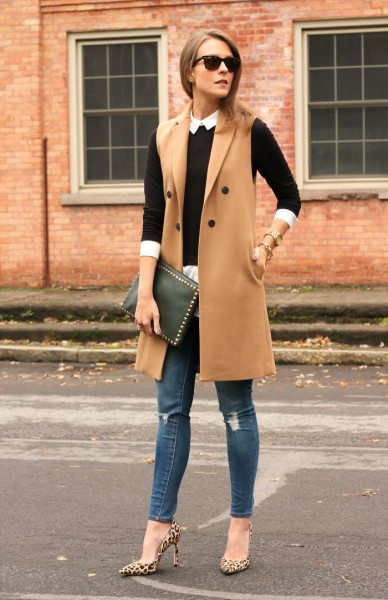 Camel vest + black fitted sweater + white button up + jeans + leopard pumps