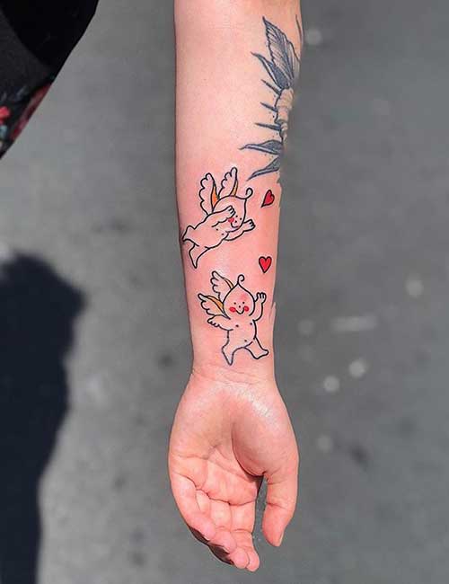 Cherubs tattoo design on the wrist and forearm