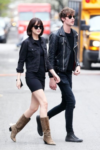 Dakota Johnson was photographed in New York City wearing a little black dress, a cropped jean jacket, and cheetah-print boots, with a one-of-a-kind accessory  in a color-coordinated outfit.
