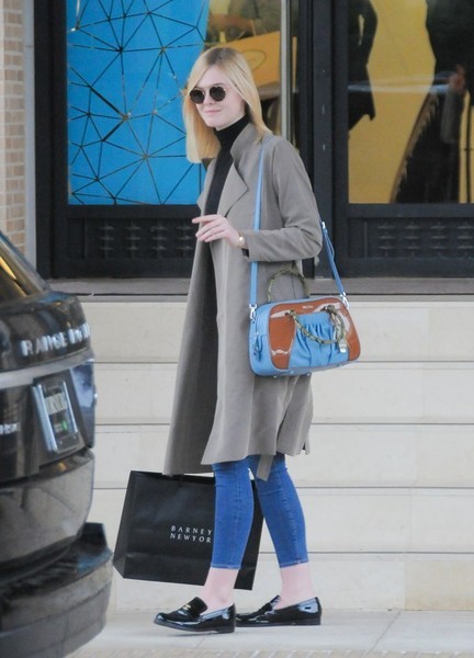 Elle Fanning teamed a taupe coat with a black turtleneck and jeans for a day of shopping in Beverly Hills.