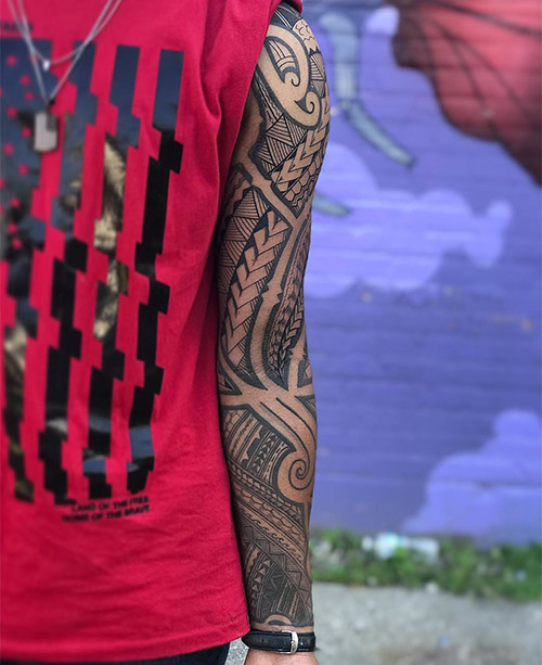 Polynesian spearhead motif tattoo symbolizing courage