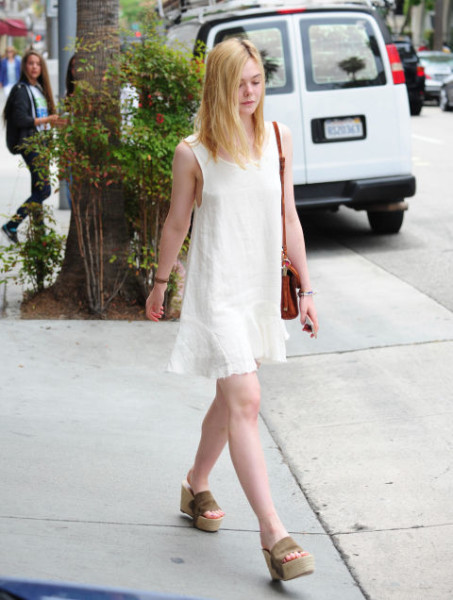Wearing a white dress with platform sandals out in Beverly Hills.