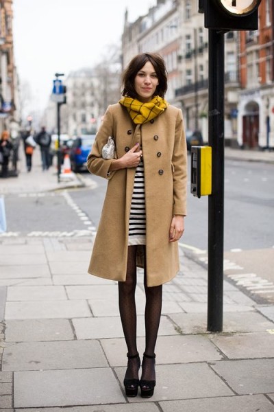 Yellow plaid infinity scarf, camel coat, striped dress, sheer black tights, and platform Mary Janes.