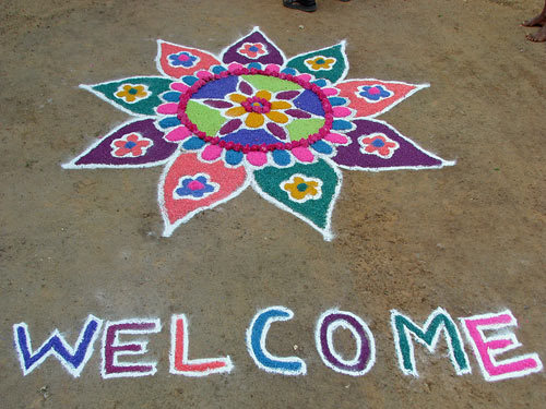 Small and colorful rangoli design decorated with diyas